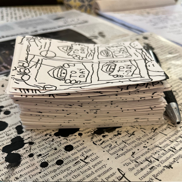 pile of sardocomics
        index cards on newspaper